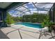 Screened-in pool area featuring a sparkling blue pool, patio space, and lush landscaping at 1740 Cherry Ridge Dr, Lake Mary, FL 32746