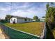 Fenced backyard with a spacious grassy area surrounding a white single-story home at 1831 Aaron Ave, Orlando, FL 32811