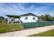 Back of home featuring fenced-in yard, side carport and grass at 1831 Aaron Ave, Orlando, FL 32811