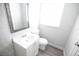 Bathroom featuring modern vanity with mirror, toilet and new flooring at 1831 Aaron Ave, Orlando, FL 32811