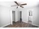 Neutral bedroom featuring modern floors, a ceiling fan, closet and convenient access to the bathroom at 1831 Aaron Ave, Orlando, FL 32811