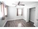 Bright bedroom featuring wood-look flooring, ceiling fan and closet at 1831 Aaron Ave, Orlando, FL 32811