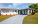 Charming home with a covered entry, long driveway, and nicely landscaped yard with colorful plantings at 1831 Aaron Ave, Orlando, FL 32811