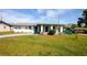 Inviting single-story home featuring a covered entryway, well-maintained lawn, and freshly painted driveway at 1831 Aaron Ave, Orlando, FL 32811