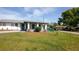 Charming home featuring well-maintained landscaping and covered front porch at 1831 Aaron Ave, Orlando, FL 32811