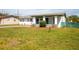 Charming home featuring well-maintained landscaping and covered front porch at 1831 Aaron Ave, Orlando, FL 32811