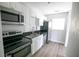 Updated kitchen featuring stainless steel appliances, sleek countertops, and white cabinetry at 1831 Aaron Ave, Orlando, FL 32811