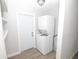 Functional laundry room with stackable washer and dryer and plenty of storage shelving at 1831 Aaron Ave, Orlando, FL 32811