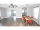 Open-concept living area with stylish wood-look floors, lots of natural light and a ceiling fan at 1831 Aaron Ave, Orlando, FL 32811