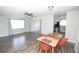 Bright living area with modern ceiling fan, wood-look floors, and dining area adjacent to an updated kitchen at 1831 Aaron Ave, Orlando, FL 32811