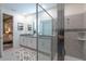 Sleek bathroom with a double vanity, granite counters, a glass shower, and an adjacent bedroom at 2004 Fleming Mist Pl, Kissimmee, FL 34747