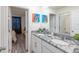 Modern bathroom with double sinks, granite countertop, and a large mirror at 2004 Fleming Mist Pl, Kissimmee, FL 34747