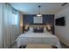 Comfortable bedroom with stylish decor, a plush bed, and modern lighting fixtures at 2004 Fleming Mist Pl, Kissimmee, FL 34747