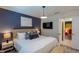 Comfortable bedroom with stylish decor, a plush bed, and modern lighting fixtures at 2004 Fleming Mist Pl, Kissimmee, FL 34747