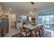 Stylish dining room showcases modern lighting, ample seating, and seamless connection to the inviting living area at 2004 Fleming Mist Pl, Kissimmee, FL 34747