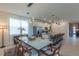 Elegant dining room with a modern chandelier, stylish table, and views of the open kitchen at 2004 Fleming Mist Pl, Kissimmee, FL 34747