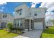 Contemporary two-story home boasting a stone facade, covered entryway, and a well-manicured front yard at 2004 Fleming Mist Pl, Kissimmee, FL 34747