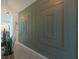 Hallway featuring contemporary design elements, including a unique wall pattern, and a glimpse of the kitchen at 2004 Fleming Mist Pl, Kissimmee, FL 34747