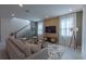 Bright living room showcasing modern decor, a stylish accent wall, and an adjacent staircase at 2004 Fleming Mist Pl, Kissimmee, FL 34747