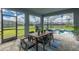 Covered patio with a dining table, barbecue grill, and view of the refreshing pool at 2004 Fleming Mist Pl, Kissimmee, FL 34747