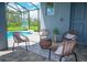 Inviting screened-in patio with comfortable seating area and view of the sparkling pool at 2004 Fleming Mist Pl, Kissimmee, FL 34747