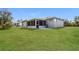 Expansive backyard view showing a screened-in porch and spacious lawn at 2081 Galveston Ave, Deltona, FL 32725