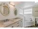 Bright bathroom features dual sinks, marble countertops, and a separate bathtub at 2081 Galveston Ave, Deltona, FL 32725