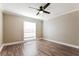 Cozy bedroom featuring wood-look floors and ample natural light at 2081 Galveston Ave, Deltona, FL 32725