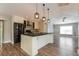Stylish kitchen with island, stainless steel appliances, and modern pendant lights at 2081 Galveston Ave, Deltona, FL 32725