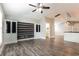 Open-concept living room featuring wood-look floors and built-in cabinets at 2081 Galveston Ave, Deltona, FL 32725
