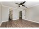 The primary bedroom features wood-look floors, neutral walls, and an ensuite bathroom at 2081 Galveston Ave, Deltona, FL 32725
