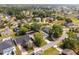 Neighborhood aerial view showcases well-kept homes, lush greenery, and quiet streets under a bright sky at 211 Dalton Dr, Kissimmee, FL 34758