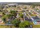 A neighborhood view with green foliage and an aerial view of a suburban landscape at 211 Dalton Dr, Kissimmee, FL 34758