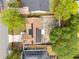 A suburban home with solar panels is surrounded by trees and a fenced in yard at 211 Dalton Dr, Kissimmee, FL 34758