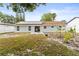 A backyard featuring a well-maintained lawn and a covered patio area at 211 Dalton Dr, Kissimmee, FL 34758