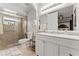 Modern bathroom features a large white vanity, a glass-enclosed shower, and neutral tiling at 211 Dalton Dr, Kissimmee, FL 34758