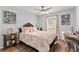 Relaxing bedroom features hardwood floors, a ceiling fan, a window, and personalized decor at 211 Dalton Dr, Kissimmee, FL 34758