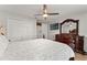 Spacious bedroom boasts a ceiling fan, hardwood floors, and decorative dark wood furniture at 211 Dalton Dr, Kissimmee, FL 34758