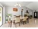Dining area with modern lighting, tile floors, neutral walls, and sliding glass door at 211 Dalton Dr, Kissimmee, FL 34758
