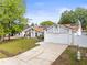 Inviting single-story home featuring a spacious driveway, solar panels, and landscaped front yard at 211 Dalton Dr, Kissimmee, FL 34758