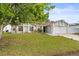 Charming single-story home with a well-manicured lawn and colorful flower beds at 211 Dalton Dr, Kissimmee, FL 34758