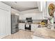 Spacious kitchen featuring stainless steel refrigerator, white cabinets, and granite countertops at 211 Dalton Dr, Kissimmee, FL 34758
