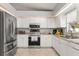 Well-lit kitchen with stainless steel appliances, granite countertops, and ample cabinet space at 211 Dalton Dr, Kissimmee, FL 34758