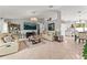 Open-concept living room featuring tile floors, neutral paint, modern decor, and plenty of natural light at 211 Dalton Dr, Kissimmee, FL 34758