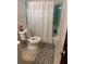 Compact bathroom with a toilet, tub/shower combination, and tiled walls at 2207 Virginia Ave, Eustis, FL 32726