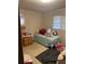 Modest bedroom featuring a twin bed, side table, and natural light at 2207 Virginia Ave, Eustis, FL 32726