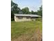 Modest single-story home featuring red trim and a covered front entrance at 2207 Virginia Ave, Eustis, FL 32726