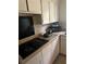 Functional kitchen with white cabinets, tile backsplash, and an electric stovetop at 2207 Virginia Ave, Eustis, FL 32726
