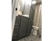 Stylish bathroom with dark gray cabinets, patterned floor tiles, and a shower with a patterned curtain at 222 Georgetown Dr # C, Casselberry, FL 32707