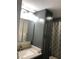 Nicely finished bathroom with grey cabinetry, modern lighting, and shower with patterned curtain at 222 Georgetown Dr # C, Casselberry, FL 32707